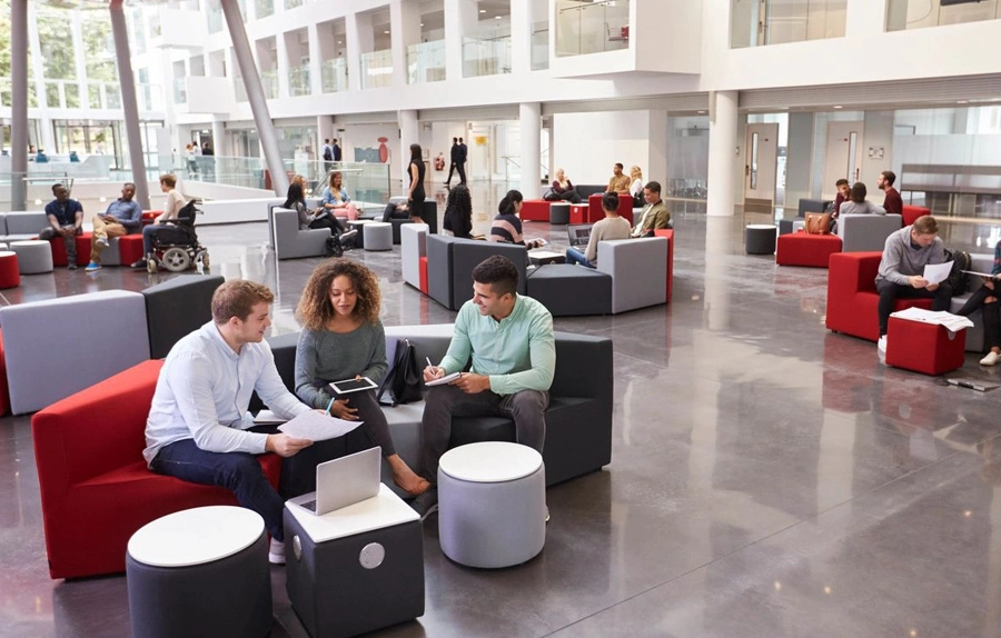 A group of people sitting around in an office building.