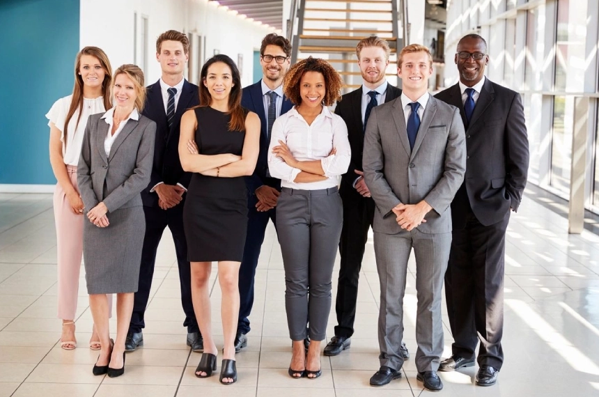A group of people in business attire standing together.