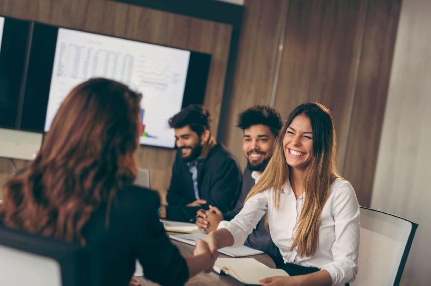A group of people sitting around a table.