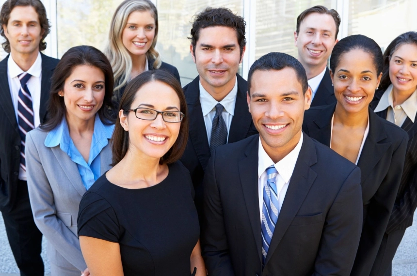 A group of people in business attire posing for the camera.