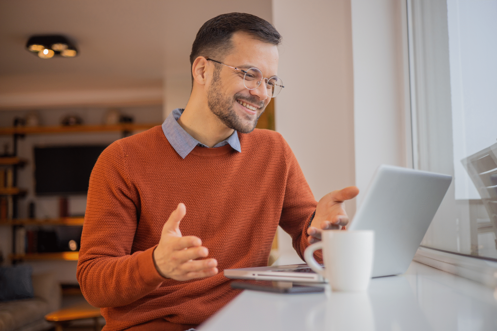 Man smiling during video call at laptop