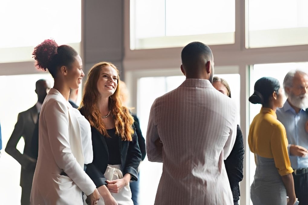 Diverse professionals networking in bright conference space