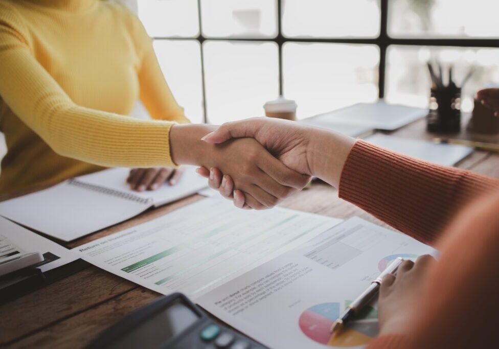 Business investor group shakes hands, Two businessmen are agreeing on business together and shaking hands after a successful negotiation. Handshaking is a Western greeting or congratulation.